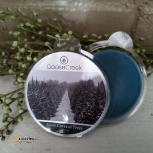 Goose creek wax melts snow covered trees